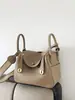 Capa Superior Piel de Vaca Togo Lindy Bolso de Piel Genuina para Mujer 2025 Nuevo Retro Europeo y Americano Bolso Cubo Moda Mano Bolso de Piel Genuina para Mujer