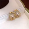 Pendientes de botón con colgante de cesta de flores de perlas de aguja de plata europea y americana, diseño personalizado, pendientes con sentido de diseño, joyería para orejas de lujo ligero, alta gama, para mujer