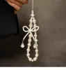 Yi Personalizado Criativo Strass Pérola Laço Corrente de Mão Cordão de Pulso Capa de Celular Câmera Pingente Versátil Novo Estilo