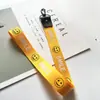 Acessórios para Capinha de Celular com Letra e Rosto Sorridente Mais Vendidos, Cordão, Alça de Pescoço, Capinha de Celular Feminina da Moda, Pingente para Bolsa