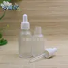 Botella transparente esmerilada para aceites esenciales al por mayor botella cosmética botella con gotero botella de vidrio botella vacía blanco grano fino cabeza de goma blanca