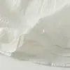 Toma real de blusa casual simple de estilo artístico de ajuste holgado para el verano de 2026, con cuello redondo y mangas cortas tipo volante, estilo japonés relajado para mujer