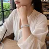 A pulseira de cristal de laço duplo original de cristal branco natural e água-marinha da Mingtai Jewelry é refrescante e versátil para o verão, com um design fresco e simples.