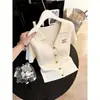 Cárdigan de punto de manga corta con cuello en V de moda de estilo europeo de alta gama para mujer 2026 Verano Nuevo Top versátil adelgazante