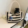 Bolso de mano tejido a rayas de moda transfronterizo 2026 nuevo versátil para el trabajo bolsa grande estilo coreano de gran capacidad para mujer