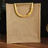 Bolsa de arpillera Asa de bambú Arpillera Buda Té Bolsa individual Bolsa publicitaria Bolsa de compras Bolso de mano Bolsa de lino Al por mayor Ecológico Para llevar en la mano