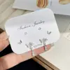 Pendientes pequeños diarios dorados simples tres pares de traje aguja de plata para mujer estudiante exquisitos pendientes de estrella de mariposa al por mayor