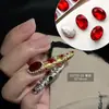 Venta al por mayor de Materiales de Uñas Trendy Estilo Chino Huanhuan, Pedrería de Punta Color Esmeralda Famosa en Internet, Pedrería Redonda de Fondo Plano y Accesorios de Uñas de Perlas