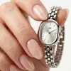 Reloj popular para mujer transfronterizo, reloj versátil artístico de alto valor de nicho, simple y elegante para mujer con esfera ovalada