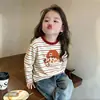 Camiseta de manga larga a rayas de algodón puro, corte holgado estilo coreano para niñas, nuevo modelo primavera y otoño 2026, top básico con bloques de color para niñas