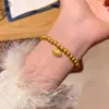 Pulsera de cuentas con colgante de amuleto de moneda estilo chino nuevo, sensación vintage de nicho de alta gama, accesorio de mano moderno y simple