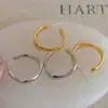 Pendientes de aro metálicos 2026 nuevo modelo popular, lujo ligero de alta gama, pendientes de botón elegantes, joyería de nicho única, encanto femenino