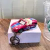Llavero de coche cool de fricción, divertido llavero colgante de modelo de juguete de motocicleta para aliviar el estrés, al por mayor