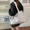Bolsa de lona a rayas estilo perezoso nicho coreano para mujer 2026 nueva gran capacidad versátil para el trabajo bandolera