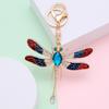 Nuevos accesorios de colgante de libélula de diamante europeos y americanos, llavero de metal creativo, insecto hueco, piezas de automóvil, pequeños regalos