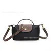 Bolsas Populares Transfronteiriças para Mulheres Outono e Inverno 2025 Nova Bolsa de Bolinho de Nylon de Alto Padrão Versátil Bolsa de Ombro Transversal