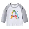 2026 Nova Camiseta Infantil Transfronteiriça Primavera e Outono Gola Redonda Desenho Animado Manga Longa Camisa Básica para Meninos e Meninas Camiseta de Algodão para Bebê