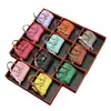 Nuevo y moderno colgante de mini bolso de platino, bolso de lipstick de alta gama, decoración de bolso para auriculares, accesorio de llavero para coche, venta al por mayor
