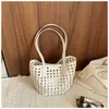 Bolso cubo de un solo hombro calado estilo coreano para mujer, nuevo modelo de verano 2026, bolso tote tejido dos en uno para vacaciones y viajes