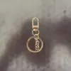 Llavero de hebilla de puerta giratoria, cadena de cuatro secciones, hebilla de ocho, colgante de cuenta, decoración de bolso, llavero, accesorios para llavero