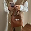 Bolso tipo cubo simple y elegante de alta calidad con patrón de lichi para mujer, nuevo estilo Primavera 2026, bolso de mano y bandolera para el día a día