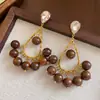 Pendientes de borla con carcasa de madera marrón transfronterizos europeos y americanos, pendientes de estilo vintage Maillard, pendientes de mujer de lujo ligero de alta gama