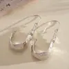 Brincos de gancho em U irregulares exagerados em estilo europeu e americano, brincos de metal de moda personalizados transfronteiriços, brincos de nicho de alta qualidade e resistentes