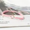 Pulsera tejida de nudo plano de trébol de cuatro hojas de venta caliente transfronteriza para parejas y estudiantes, tendencia europea y americana inspirada en la dopamina, joyería al por mayor de fabricante