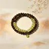 Elegante y sofisticado nuevo brazalete de la fortuna de doble bucle de cristal amarillo y ojo de tigre estilo chino, regalo de nicho de alta gama, disponible para venta al por mayor