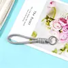 Fabricante de origen de accesorios de cordón tejido de nailon de colores macarrón, accesorios para llaveros DIY para cámaras y botellas de agua
