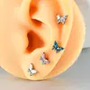 Unha de osso da orelha de liga de titânio F136 com zircônia em formato de borboleta, rosca interna, unha labial em T, brinco de titânio para piercing na orelha