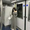 Roupa de primavera cedo: um conjunto de duas peças apresentando um top pequeno, ombro a ombro, de manga longa e com efeito rejuvenescedor, e calças casuais de perna larga