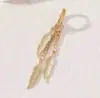 Pendientes de Aro con Cadena de Plumas de Venta Caliente de Comercio Exterior Transfronterizo Europeo y Americano Pendientes para Hombre Pendientes de Plumas