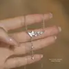 Collar de mariposa de nácar de plata pura S925 para mujer, moda 2025 nicho ins lujo ligero cadena larga de borla de nácar para clavícula