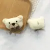 Nueva cabeza de animal de dibujos animados Muñeco de algodón tridimensional Oso con lazo Accesorios de decoración Oso festivo bufanda guantes accesorios