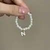 Mini Labubu Cuarta Generación Caja Sorpresa Ropa de Muñeca Collar Colgante Labubu 26 Letras Collar de Perlas Accesorios de Joyería