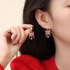 Pendientes de estilo nacional chino nuevos de 2024, pendientes rojos de la fortuna Xingshi, diseño de nicho, pendientes festivos de Año Nuevo que combinan con todo.