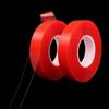 Cinta adhesiva nano de doble cara transparente con película roja, resistente a altas temperaturas y que no deja marcas. Cinta adhesiva nano de doble cara acrílica transparente con película roja.