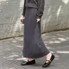 Nova moda outono e inverno: saia midi de malha de lã feminina com toque macio e texturizado, cintura alta, silhueta evasê e design longo e fluido