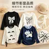 Nueva colección de Primavera y Otoño: Camisetas básicas de manga larga con cuello redondo para niñas, con lindos estampados de moños, disponibles al por mayor