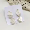Coreia do Sul Dongdaemun mesmo estilo concha natural cortada redonda brincos de franja originais primavera novo brincos de metal fosco