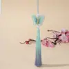 Bordado de mariposa en degradado dorado estilo nacional falda antigua con cara de caballo accesorios colgantes borla de púas hecha a mano joyería al por mayor
