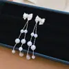 Pendientes de aguja plateada con corazón de circón, lazo y borla de perlas, pendientes de lujo ligero de alta gama, pendientes colgantes exquisitos y dulces