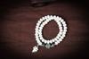 Hainan Jade Blanco Bodhi natural caramelo arcoíris meteorizado multicolor degradado rosario pulido a mano colgante mano de Buda tallada
