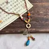 Collar de Pluma de Bronce Retro Estilo Bohemio para Mujer 2026 Cadena para Suéter Estilo Étnico Sensación de Alta Gama Accesorios de Ola Regalo