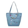 Bolso de hombro de gran capacidad para mujer 2026, bolso simple de tela, bolso de doble cara con diseño de dibujos animados de alta apariencia para mujer