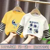 Camiseta de manga larga de algodón puro para niño, nuevo modelo primavera y otoño 2026, camiseta básica con estampado de dibujos animados para niño, top falso de dos piezas, moderno