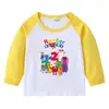 2026 Nova Camiseta Infantil Transfronteiriça Primavera e Outono Gola Redonda Desenho Animado Manga Longa Camisa Básica para Meninos e Meninas Camiseta de Algodão para Bebê