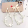 Cordón para teléfono móvil con forma de corazón y lazo de perla para niña, cadena de cuentas hecha a mano, colgante corto en forma de U para mujer