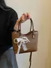 Bolso de cubo tejido de nicho transfronterizo 2026 nuevo bolso de cesta de moda para mujer bolso de mano simple para hombro cruzado